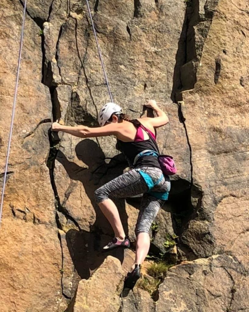 Attendee ascending the rockface